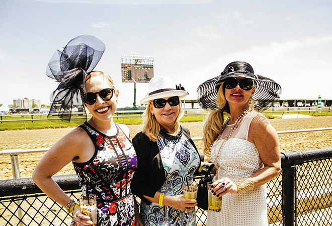 Three women in fancy hats at the Black-Eyed Susan Race.