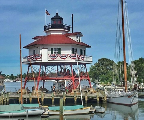 Drum Point Lighthouse with boats in foreground.