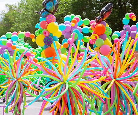 A parade with lots of colorful balloons.