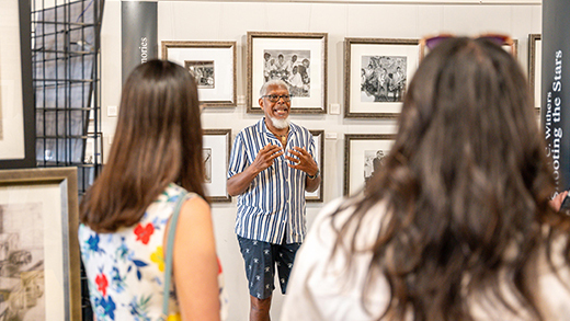 A guide leading a group on a tour of the Withers Collection Museum & Gallery.