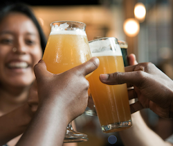A group toasting beer glasses together.