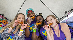 Contestants biting into hot wings at the World Championship Hot Wing Contest and Festival.