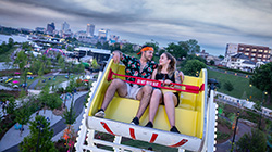 Couple on the Ferris wheel at RiverBeat Music Festival with the concert stage and Memphis skyline in the background.