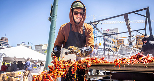 A man prepares crawfish at the Rajun Cajun Crawfish Festival in downtown Memphis