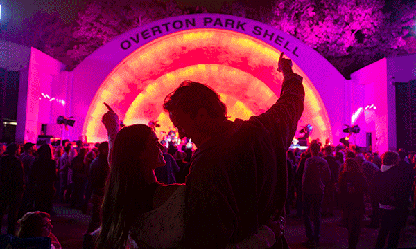 A rotating series of images showing a couple enjoying a concert at the Overton Park Shell,spectators watching the golfers at the FedEx St. Jude Championship and guests on the Peabody Rooftop for their weekly parties.