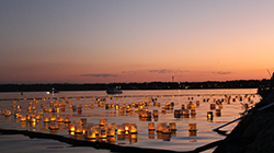 Water lanterns floating at sunset during the Water Lantern Festival.