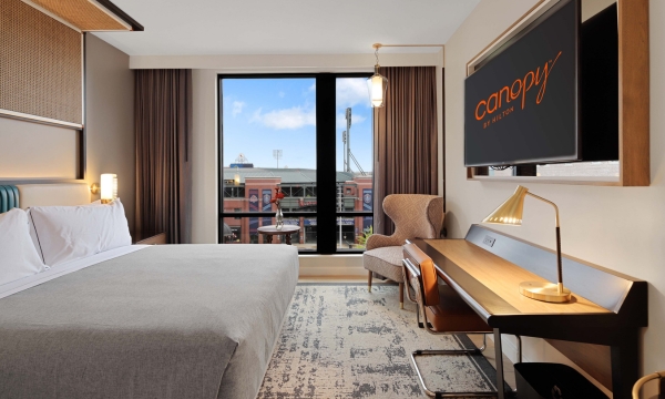 Inside a king guest room with a view of AutoZone Park at Canopy Memphis Hotel.