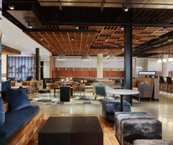 Tables, chairs, couches and more seating inside the lobby at Canopy Memphis Hotel.