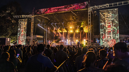 A crowd of people enjoy an outdoor concert at Mempho Music Festival.