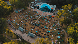 An aerial view of the Overton Park Shell, lit up during a fall concert.