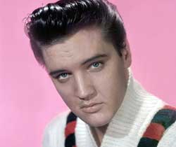 A profile shot of Elvis Presley with a pink background. 
