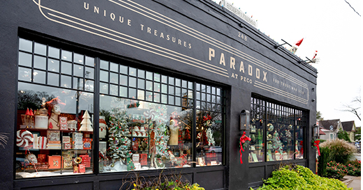 The exterior storefront of Paradox at Peco, with Christmas decor in the window.