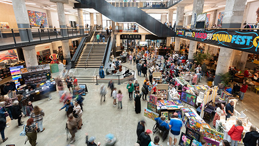 Aerial view of shoppers browsing the goods at Crafts and Drafts Holiday Market at Crosstown Concourse.