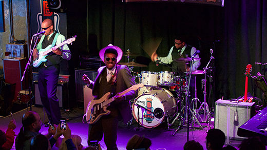 A blues band performing on stage at B.B. King's Blues Club during the International Blues Challenge.