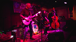 A band on stage of a blue club on Beale Street during the International Blues Challenge.