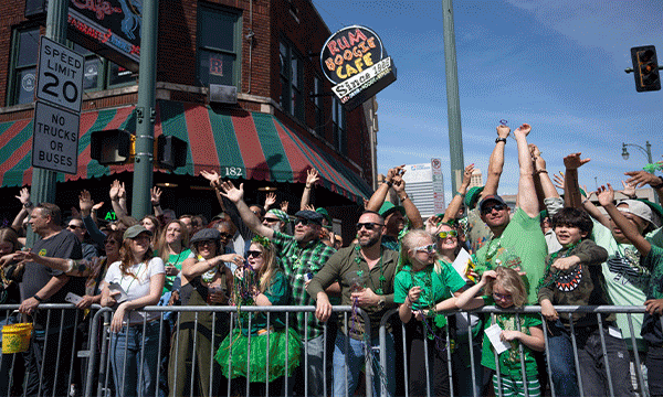 A rotating series of images showing festive folks in green outside Rum Boogie Cafe on Beale Street during the Silky O'Sullivan St. Patrick's Day Parade, a band playing in front of a crowd from the front porch of a home during Cooper-Young Porchfest, and a woman walking through the tulip gardens during the spring bloom at Dixon Gallery & Gardens.