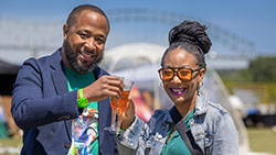 Two people toasting drinks at Mimosa Festival Memphis. 