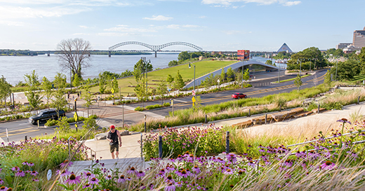 A view of Tom Lee park on the Mississippi Riverfront with the Hernando de Soto Bridge and Bass Pro Shops at the Pyramid in the background.