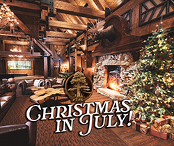 A flyer for Christmas in July at Big Cypress Lodge with a Christmas Tree next to a fireplace in a rustic lodge setting.