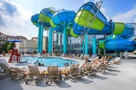 A water slide over an outdoor pool.