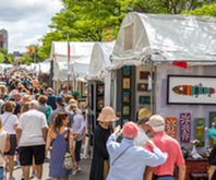 Shoppers browsing tents at an art fair in downtown Ann Arbor. 