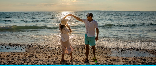 A couple dancing on a beach.
