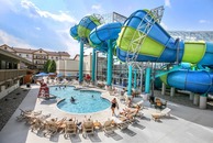 A waterslide above an outdoor pool. 