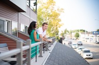 A couple on a balcony overlooking Water Street. 