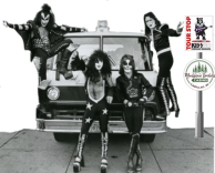 A vintage photo of the band KISS posing around a fire truck. 