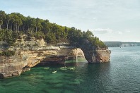 Kayakers paddling beside Lover's Leap at Pictured Rocks National Lakeshore.