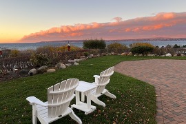 Lounge chairs on a hill overlooking Little Traverse Bay. 