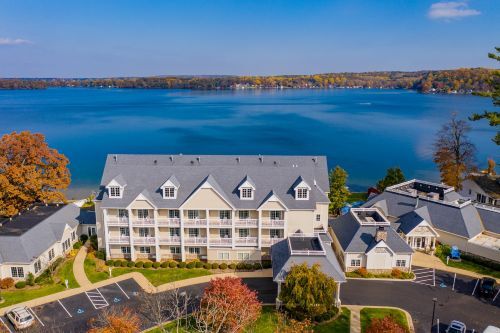 A hotel on the shore of a bay during fall. 
