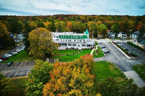 A hotel surrounded by fall trees. 