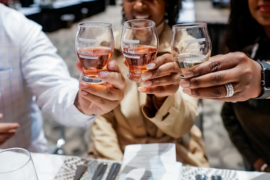 A group of friends toasting with glasses of wine. 
