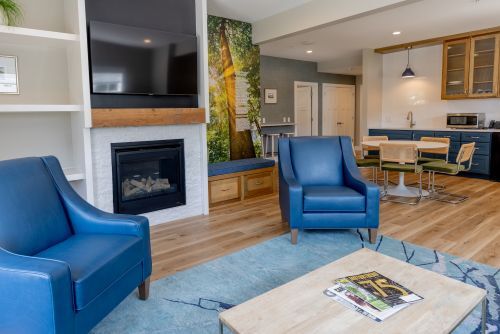 A living room with a fire and coffee table in a rental cottage.