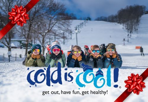 A group of children in the snow at a ski hill with overlayed text reading "Cold is Cool". 