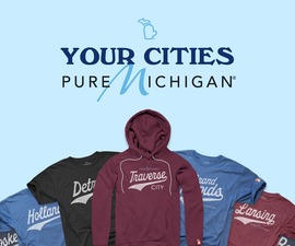 T-shirts and a sweatshirt with Michigan-themed designs.