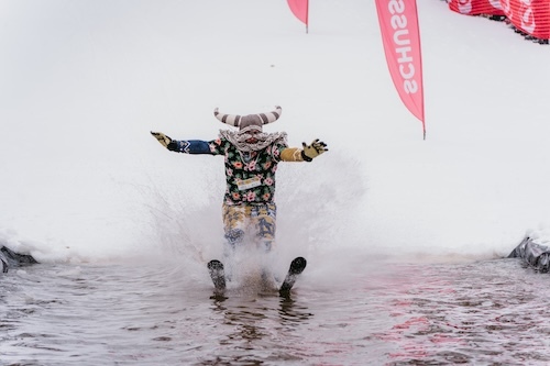 guy in clown gear water skiing at the Shanty Creek resort event end of ski season.