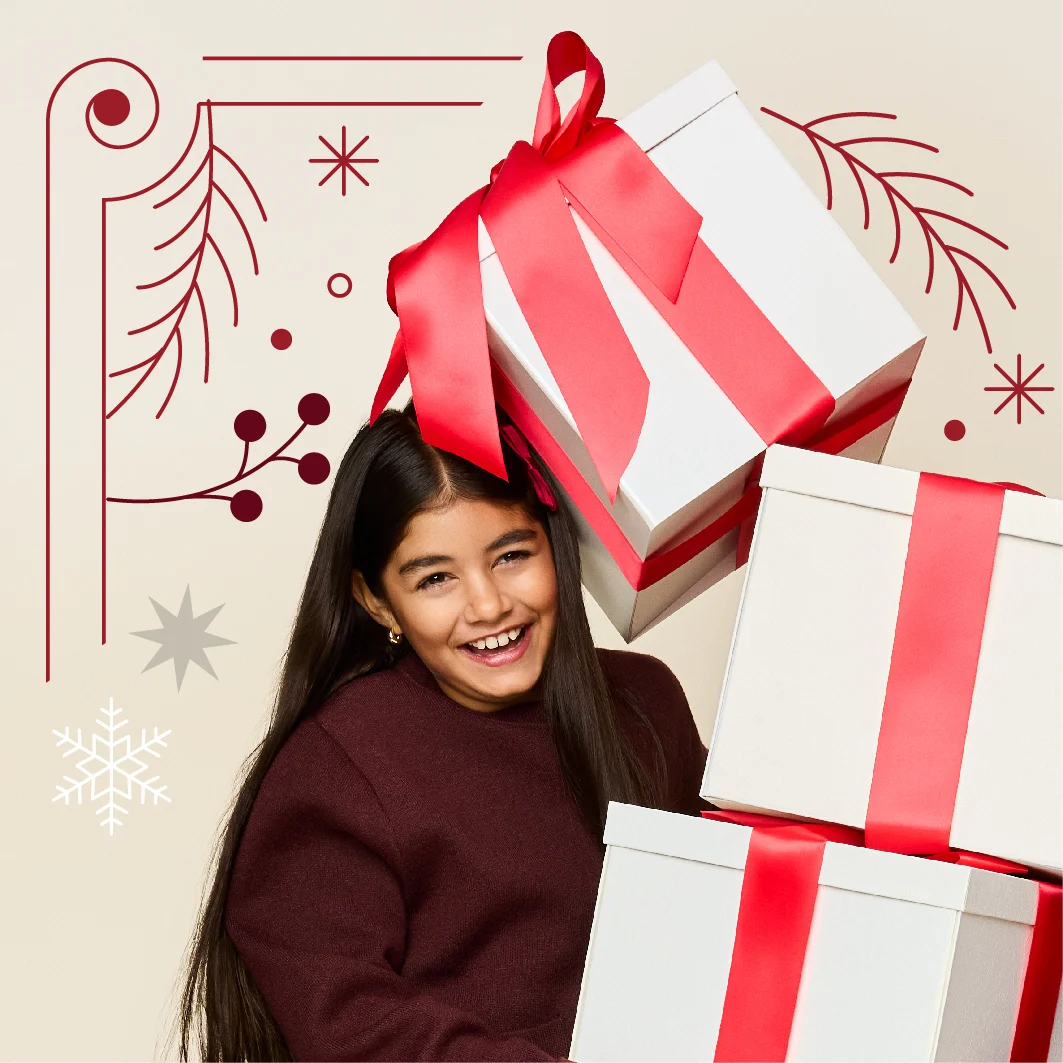 A child holding three gifts stacked on top of each other