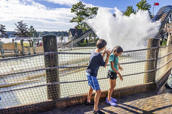 two kids about to get splashed by a water ride
