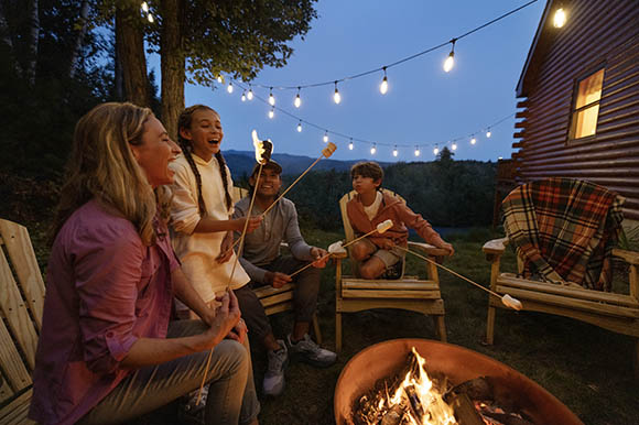 a family sitting around a campfire