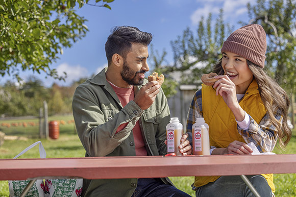 a couple eating cider donuts