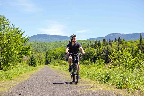 a man riding a bike on a flat path 