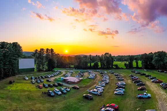 an aerial view of a drive in theater at sunset