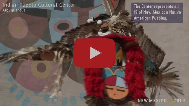 A dancer in traditional Indigenous dress dances