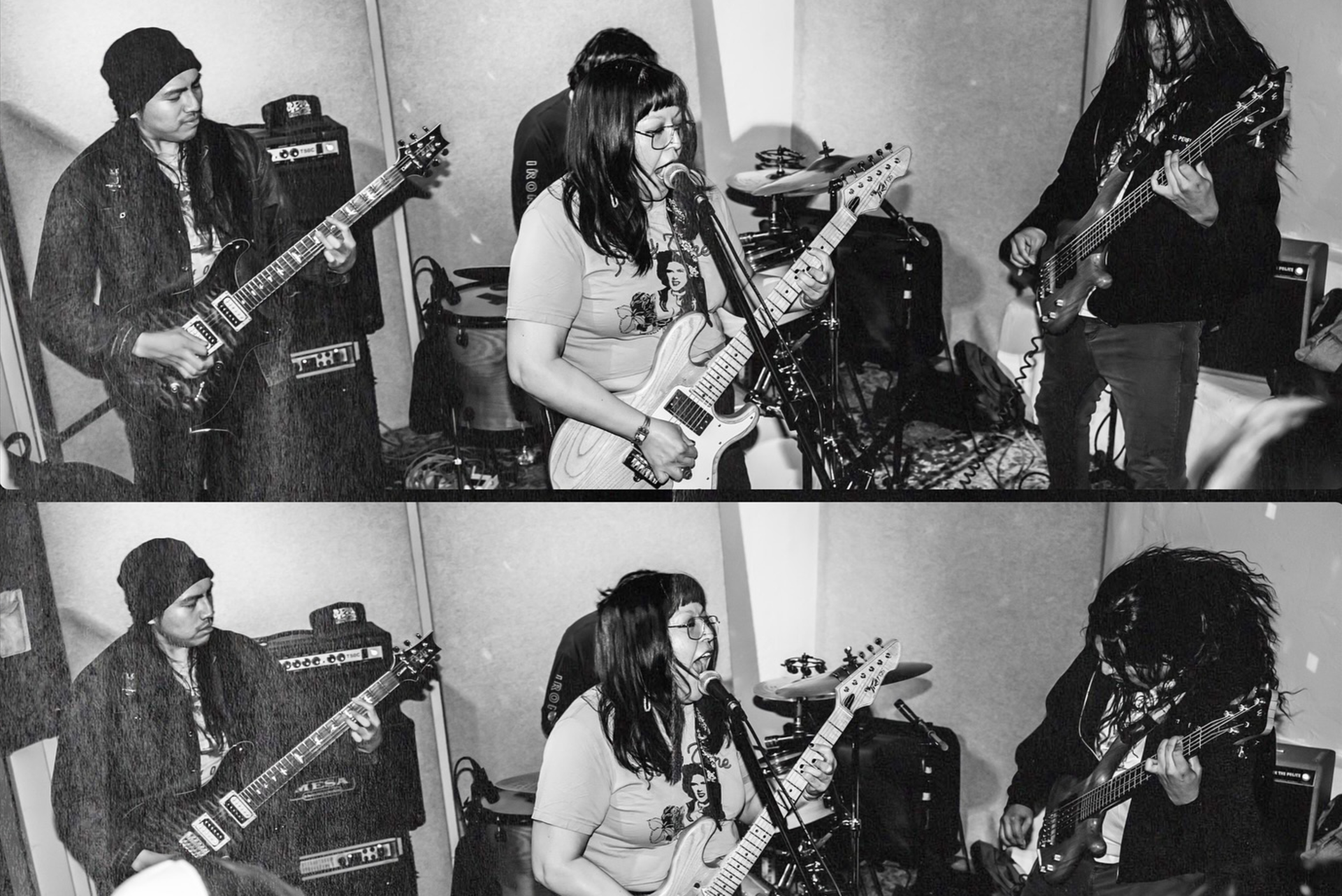 Members of a band performing in a studio with electric guitars and amplifiers, shown in a black and white photo.