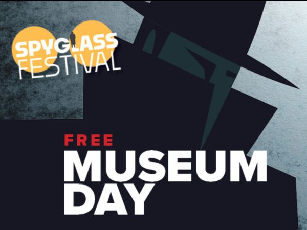 Promotional graphic for Spyglass Festival featuring Free Museum Day, with stylized text and abstract design elements in dark and orange tones.
