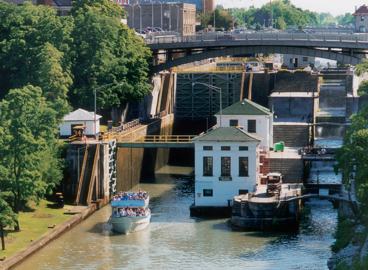 A sightseeing boat travels through the historic Erie Canal Locks in Lockport, showcasing one of Niagara County's iconic engineering landmarks.