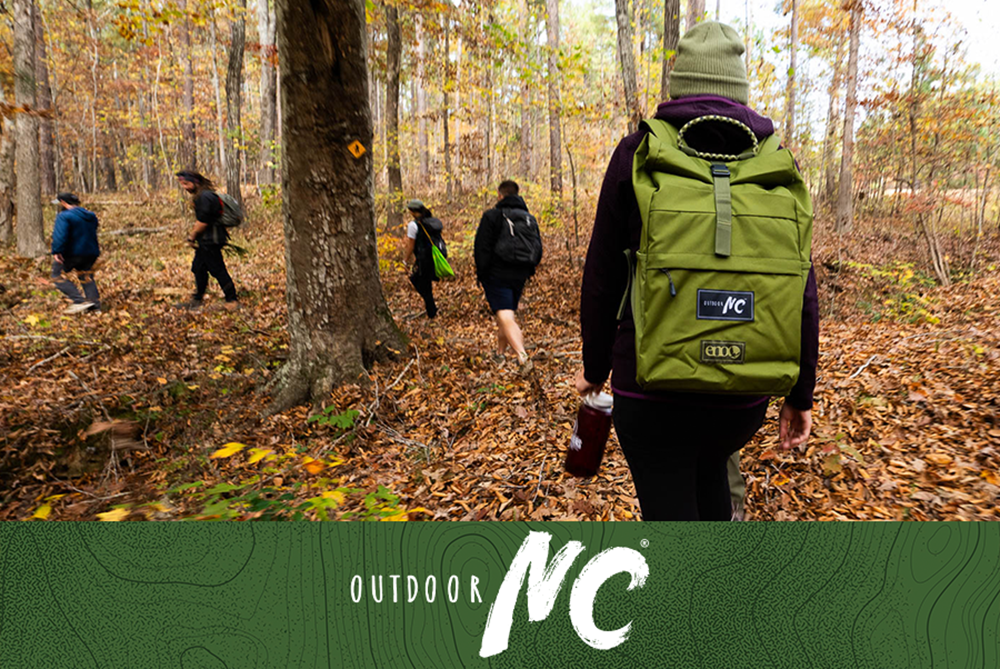 Hikers on a guided adventure in Falls Lake State Recreation Area.