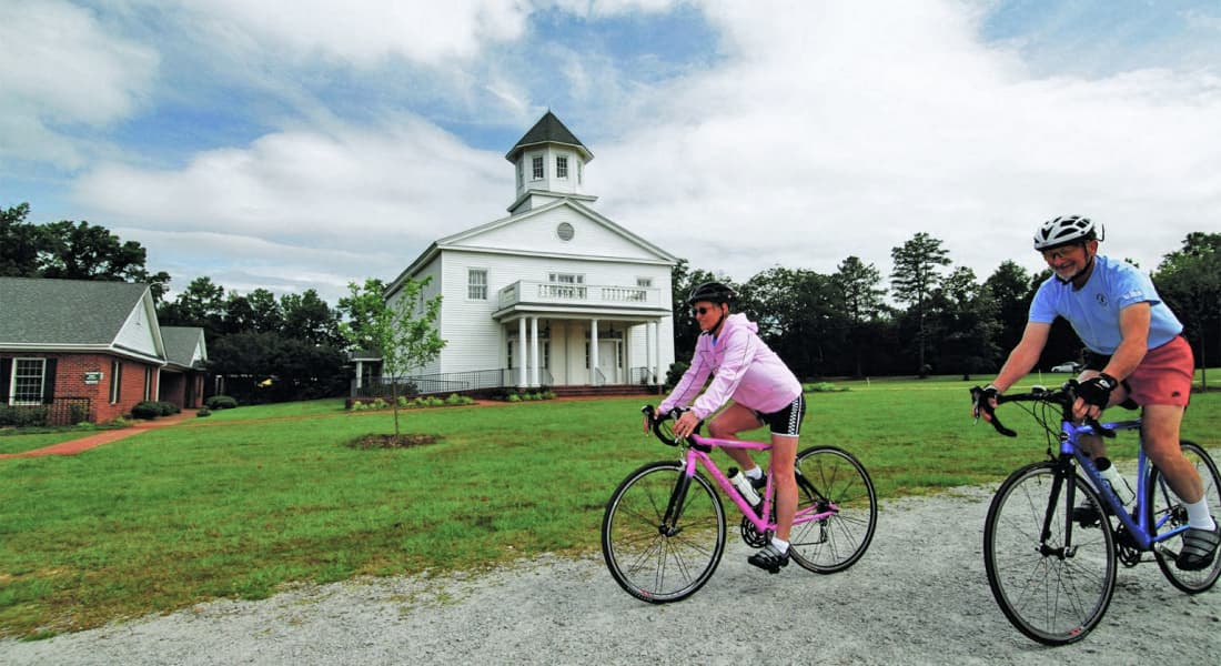 Couple bike riding on path in Laurinburg